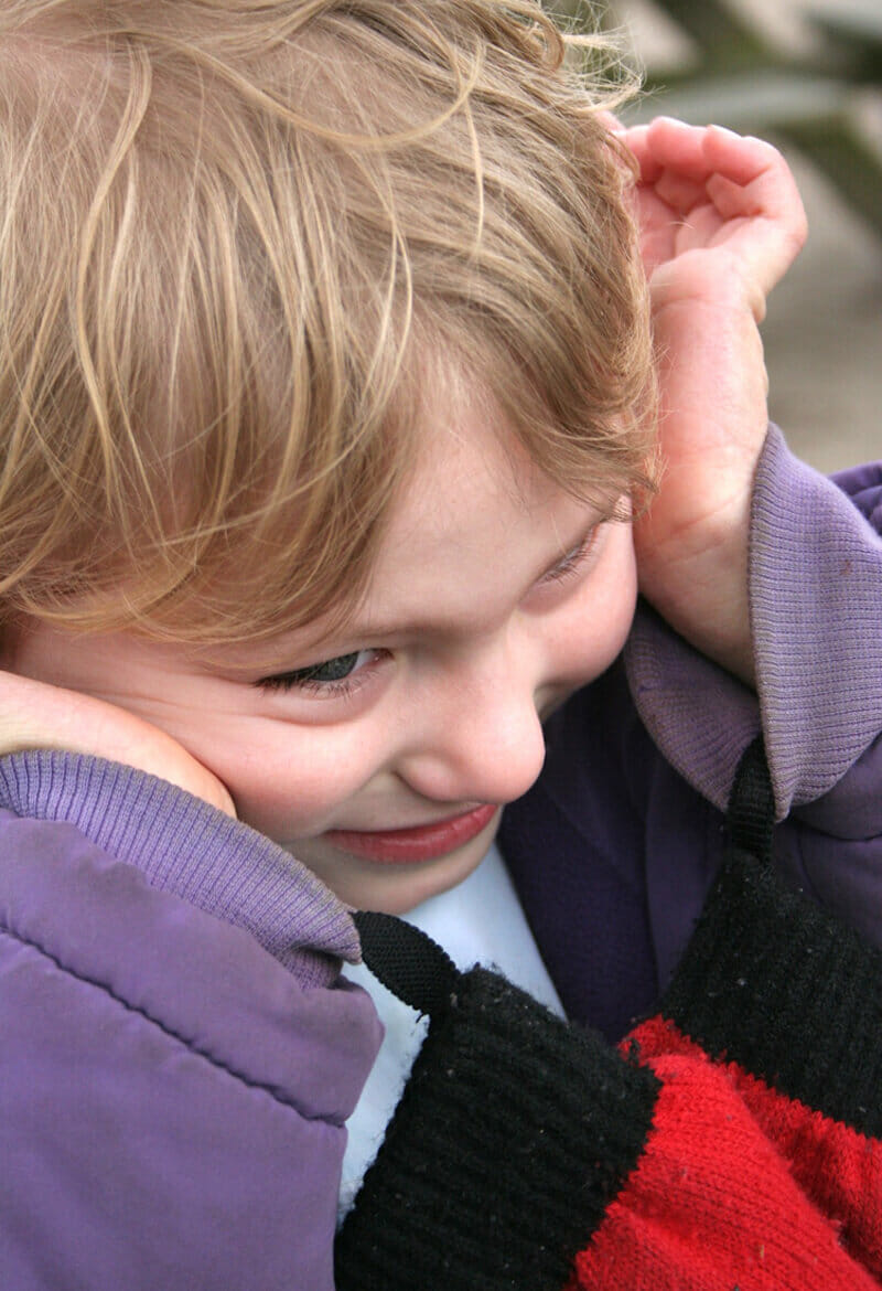 Small autistic child smiles