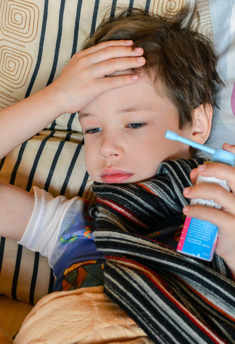 Young boy holding aesthma inhaler