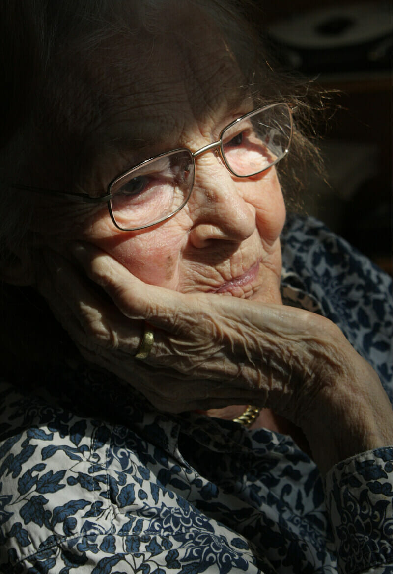 Elderly woman reflecting