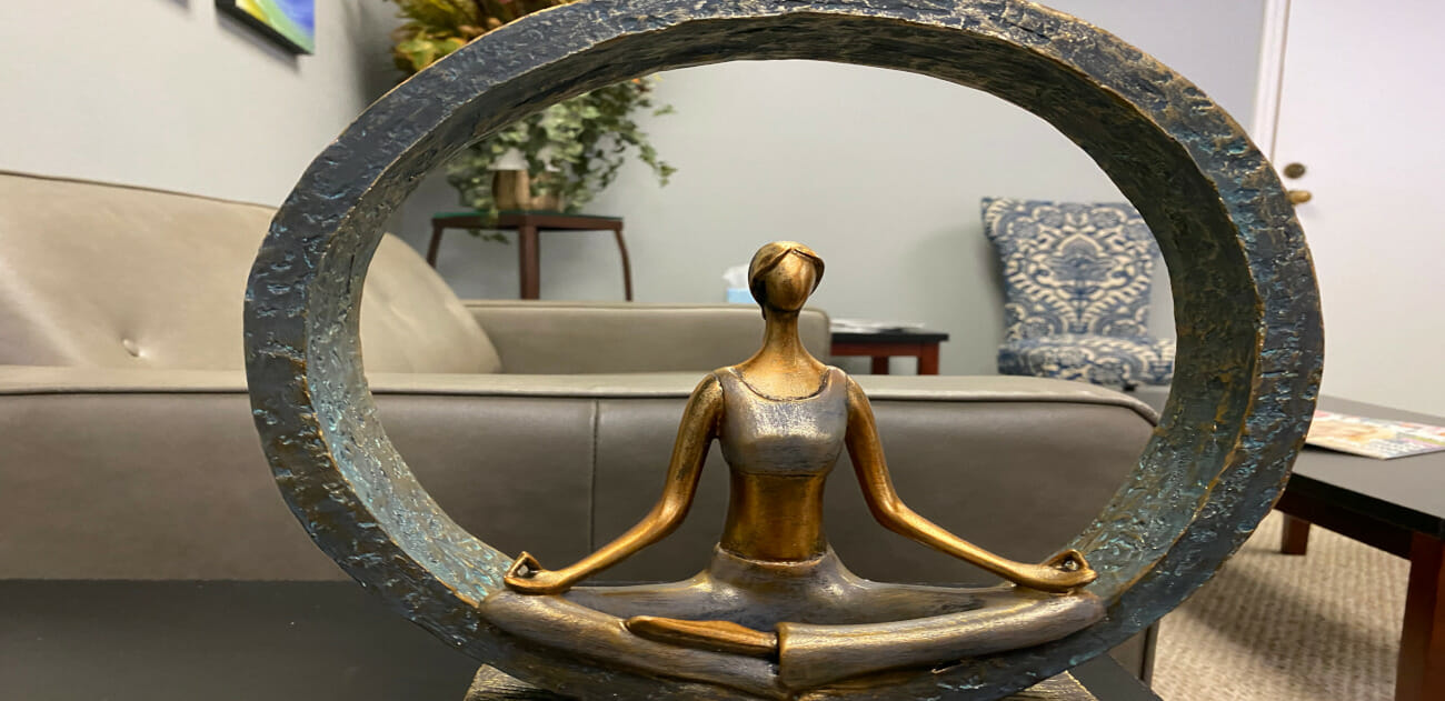 Statue of woman meditating in a large circle