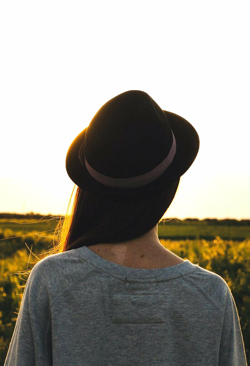 Pensive girl looks out into large field