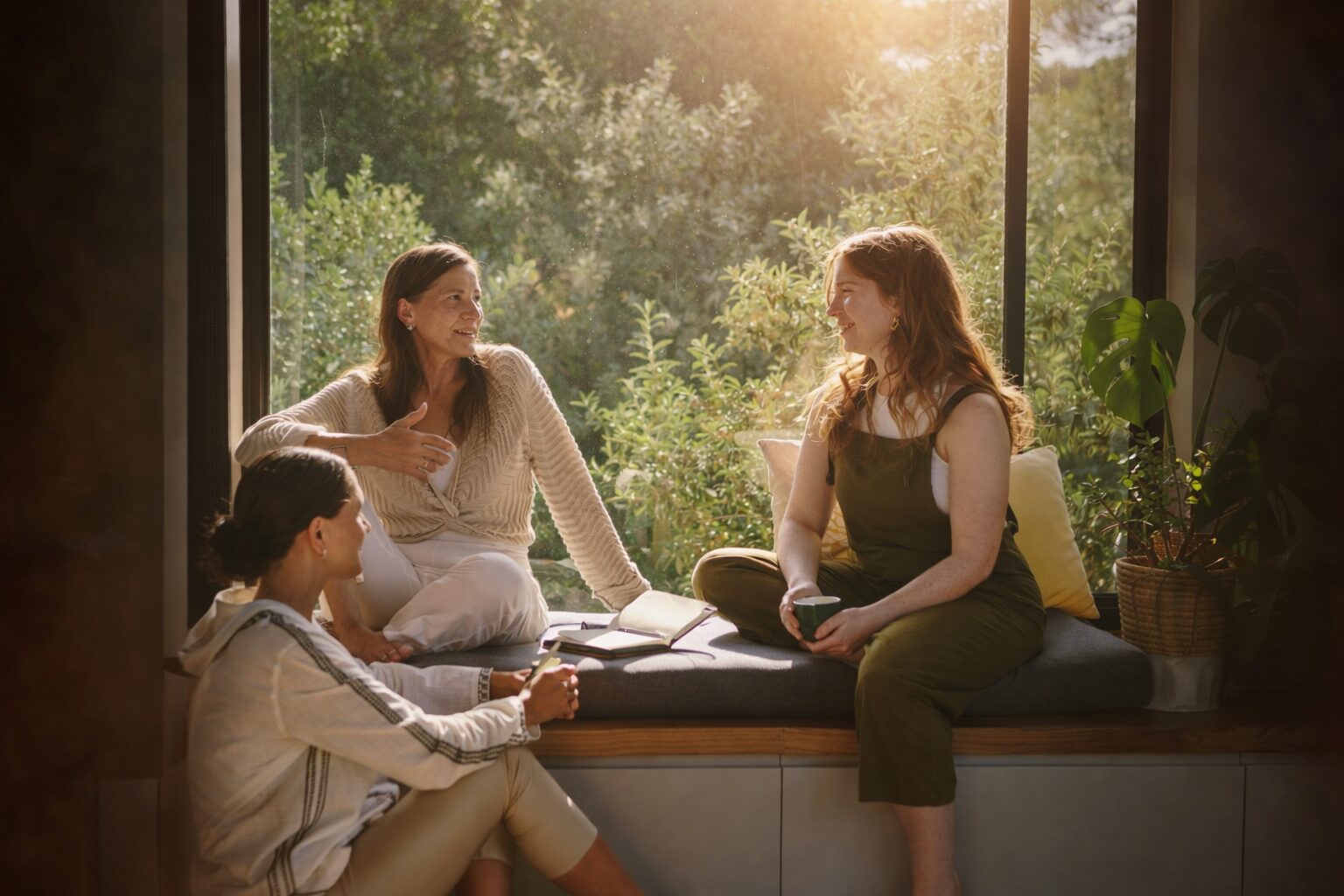 Three women iseated meaningful conversation natural light Three women iseated meaningful conversation natural light