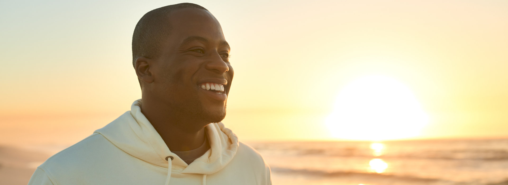 Casually Dressed Young Man in Addiction Recovery Watching Beautiful Sunrise Hopeful and Moving Forward