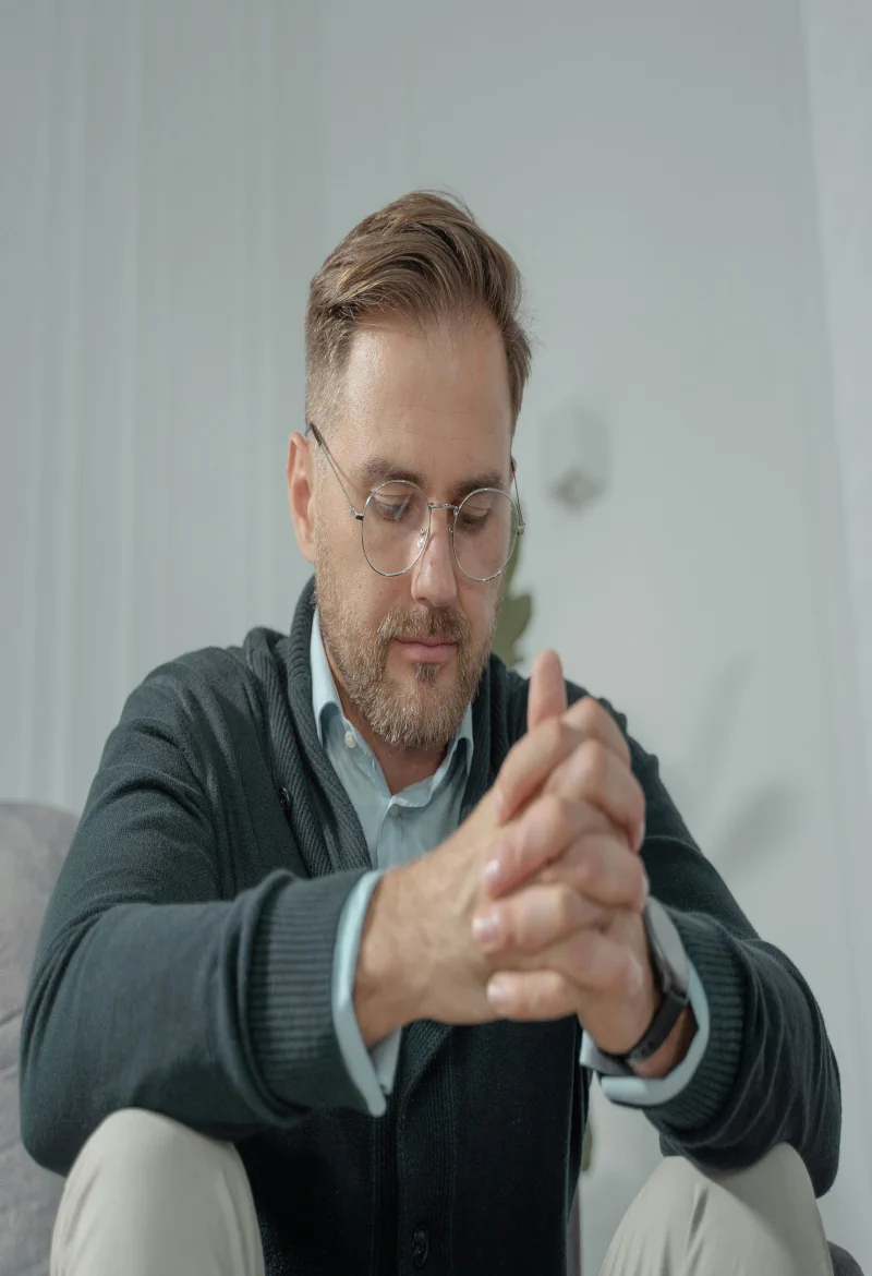 Adult man with ASD sitting quietly in a calm setting reflecting focus and self-awareness