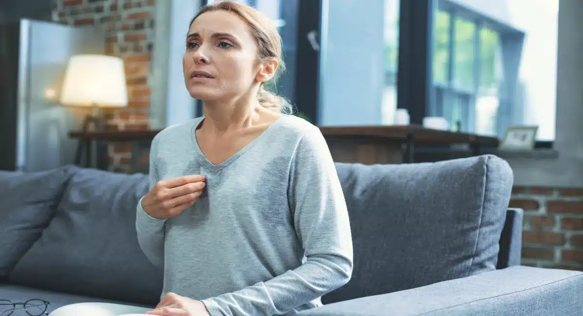 Woman pressing her hand to her chest in distress and anxious, common cocaine use health effects for those seeking cocaine addiction treatment Woman pressing her hand to her chest in distress and anxious, common cocaine use health effects for those seeking cocaine addiction treatment